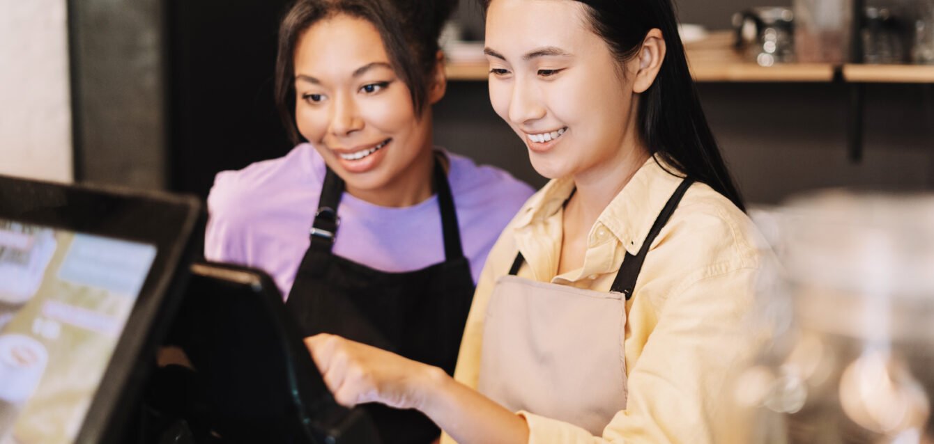Two young businesswomen working at the counter of their coffee shop Why AI Is Becoming a Revenue Tool for Modern Restaurants